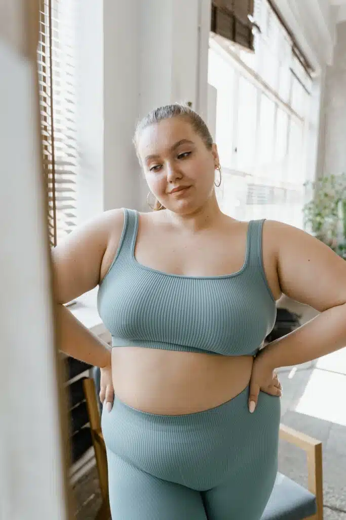 Woman in Teal Sports Bra and Brown Leggings